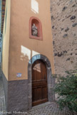 <center>Saint-Sauveur-sur-Tinée </center>  A la base du clocher, ancienne entrée de l'église. Dans une niche surmontant la porte extérieure d'accès à la sacristie (ancienne chapelle Saint-Joseph) est placée une statue de saint Paul dont l'inscription gothique qui court à sa base apprend qu'elle a été offerte en 1455 par Antoine Mondini.
L'œuvre de marbre blanc, exceptionnelle pour cette période dans une région où la peinture est l'art dominant, représente l'apôtre tenant le recueil de ses écrits et le glaive de sa décapitation, supplice réservé aux citoyens romains dont il était.
