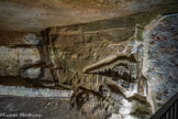 <center>Les Catacombes de Paris. </center> Sculptures de Port-Mahon. Travaillant la journée aux travaux de consolidation sous la direction de Guillaumot, il sculpte après son travail et représente une maquette ainsi que diverses vues du fort de Port-Mahon, la principale ville de l'île de Minorque, aux Baléares, où il aurait été un temps prisonnier des Anglais. Voulant parfaire son œuvre, il engage la création d'un escalier d'accès depuis le niveau supérieur de la carrière ; mais il provoque ainsi un fontis qui le tue sur le coup.