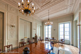 <center>Conseil Constitutionnel.</center> L'actuelle salle à manger du conseil était en fait l'antichambre de la salle à manger des appartements de Marie-Clotilde de Savoie, qui se trouve derrière les portes du fond. C'est aujourd'hui la salle Mounet-Sully, occupée par la Comédie-Française. Cette pièce est la seule à avoir conservé intégralement son décor de Fontaine de 1830, avec son plafond à caissons agrémentés de grecques et rosaces, son plancher marqueté à la flamande et ses stucs muraux qui rappellent ceux du grand escalier.