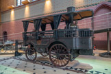 <center>Musée des Arts et Métiers.</center> Omnibus à vapeur l’Obéissante.
Amédée Bollée 1873. Fondeur de cloches de son état, Amédée Bollée construit en 1873 le premier véhicule à traction mécanique à vapeur. Il pouvait transporter un pilote, douze passagers et un chauffeur, chargé d’alimenter la chaudière de 400 litres. Nommé l’Obéissante en raison de sa grande maniabilité, il comporte certaines innovations qui permettront le développement de l’automobile.