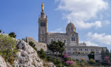 <center>Notre-Dame de la Garde</center>Le bourdon, béni en 1845, impose au bâtiment un nouvel ordre de grandeur. En 1851, les Administrateurs de Notre-Dame de la Garde demandèrent au Ministre de la Guerre l’autorisation de démolir la petite chapelle et de la remplacer par un sanctuaire plus grand surmonté d’un haut clocher. Il donna son accord le 5 février 1852. Un concours est organisé afin de déterminer les plans de la nouvelle église. Présidé par Eugène de Mazenod, le conseil d'administration tranche en faveur du projet 