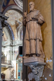 <center>L'église de La Trinité. </center> Statue de saint François de Sales, représenté en tenue ecclésiastique, montrant son livre « L’introduction à la vie dévote ». Statue petite-nature, en carton romain comprimé. Origine : « La statue religieuse », Paris, entre 1921 et 1932, acquise probablement à l’occasion de la restauration de 1929-1932.
