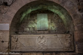 <center>Les travées des cryptes. </center>Enfeu de la religieuse Eusebia. Au-dessus du sarcophage, l’épitaphe de l’abbesse Eusebia (VIe siècle).
L’inscription, au-dessous de laquelle sont gravés deux paons de part et d’autre d’un vase, peut se traduire ainsi : « Ici repose dans la paix Eusebia, grande religieuse, servante de Dieu, qui vécut dans le siècle depuis le début de son âge quatorze années séculières et, lorsqu'elle fut choisie par Dieu, servit cinquante ans dans le monastère de Saint-Cyr. Elle s'en est allée le jour de la veille des kalendes d’octobre (un 30 septembre), l’année sixième de l’indiction ». L’indiction désignait une période de quinze ans pendant laquelle, les bases de l’impôt devaient (théoriquement) rester stables. La première indiction a débuté le 1er janvier 313, mais comme les Anciens n’ont pas numéroté les indictions successives, le décès de cette « grande religieuse », sans doute abbesse d’un monastère inconnu par ailleurs, est impossible à dater précisément. Le formulaire employé et la facture des lettres invitent cependant à attribuer le texte au VIe siècle.