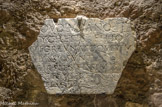 <center>Inscription antique IIe siècle, marbre.</center>Cette inscription incomplète, issue d'un ancien dallage des cryptes dans lequel elle était en réemploi, a longtemps été considérée comme chrétienne, fondant une restitution relative au martyre par le feu de deux frères. Mais ni l'ancre qui s'y trouve figurée, ni la mention du refrigerium (évocation du séjour des bienheureux pour les chrétiens mais auparavant dans les cultes d'Isis, Osiris et Serapis) ne sont spécifiques de cette religion. Ce fragment appartient sans doute à l'épitaphe de marins péris en mer. Voici la traduction que l'on peut maintenant proposer : « A (?) Sentrius Volusianus, fils de (?) Sentrius Eutyches, et à (?) Sentius Fortunatus, qui ont subi la violence de la mer {vim maris). Leur mère Hygia (a élevé ce monument) à ses fils très affectionnés. Que le vénérable Sérapis (?) nous réconforte, lui qui en a le pouvoir » (traduction J. Gascou).