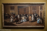 <center>Francesco Guardi</center>Venise, 1712 - 1793
Le Ridotto du Palazzo Dandolo à San Moisè, vers 1746.
Ouvert en 1638, le Ridotto de San Moisè, est une salle de jeu, la seule autorisée et gérée par la République de Venise. Les nobles qui y tiennent les tables portent la toge noire et la perruque, et ne peuvent être masqués. En revanche, les joueurs et joueuses, vénitiens ou visiteurs, profitent de l’anonymat du masque. Des intrigues se nouent. Usuriers et prostituées tiennent leur commerce et la passion irrépressible du jeu ruine des familles entières. Alarmées par la dissipation des patrimoines et la liberté des mœurs, les autorités ferment le Ridotto en 1774. En dépit des interdictions, les salles où l’on pratique les jeux comme la bassette, le pharaon ou le tric trac, se multiplient et attirent une clientèle cosmopolite.
Huile sur toile.