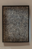 <center>Abbaye de Beaulieu-en-Rouergue  </center>Jean Dubuffet (Le Havre, 1901 - Paris, 1985)
Fragment texturologique II 
Octobre 1958 
Huile sur toile.
Appartenant à la série des Texturologity ce tableau de Jean Dubuffet présente une surface rugueuse et homogène sans forme ni tracé. Celle-ci est constituée d’une multitude de grains de sables et de fines éclaboussures de peinture que Dubuffet a projetées sur la toile placée au toi Selon l'artiste, la madère épaisse évoque un « fragment de chaussée érigé sur chevalet» mais donnant à penser d'autre partà de vastes cosmogonies sidérales en contradiction avec la très petite surface de terrain qui est supposé figurer ».
