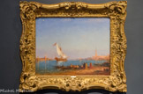 Le Bucentaure devant l’église San Giorgio Maggiore à Venise. FELIX FRANÇOIS GEORGES PHILIBERT ZIEM (1821-1911). Huile sur toile.
Depuis 1171, Venise célébrait chaque année, le jour de l’Ascension, selon des comptes immuables, dénonce du doge et de la mère, le sposalizio del mar. Monté à bord d'une galère dei parade, dont la proue représentait un centaure au corps de bœuf,  le dirigeant de la République de Venise jetait un anneau d'or symbolisant la domination de la cité sur les eaux. Cette cérémonie se tint jusqu'en 1707 date à laquelle les troupes d’invasions françaises brûlèrent le vaisseau. Passé les guerres de  la Révolution et de l’empire, Venise reconstruisit ce bateau emblématique et de grandes fêtes accompagnèrent de nouveau ses sorties en mer. Au XVIIIe siècle, lorsque les riches touristes étrangers passaient, durant leur grand tour, par Venise, nombreux furent ceux qui y séjournèrent plus longtemps que prévu pour assister à ce spectacle et à rapporter le souvenir peint par les plus célèbres « vedutistes » d'alors, tel Francesco Guardi dont le Louvre conserve une composition proche (Le Départ du Bucentaure vers Venise, vers 1775 – 1780).
Ziem renoue avec la tradition et applique les principes constructifs de ses prédécesseurs. Le Bucentaure qui vient d'arriver par la gauche de la composition apparaît de biais dans un élan dynamique, quittant le canal de San Marco pour passer entre les églises de San Marco et de San Giorgio Maggiore et rejoindre le canal de la Giudecca qui le mènera vers la mer. Des personnages de fantaisie, au premier plan, renouent avec le passé glorieux de la sérénissime.