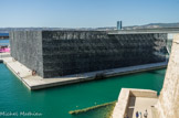 <center></center><center>Le MuCEM.</center>Entre la ville et la mer, sur l’ancien môle portuaire J4, le bâtiment est construit selon les plans de l’architecte Rudy Ricciotti, associé à Roland Carta. Ce bâtiment est relié au fort St Jean par une passerelle.