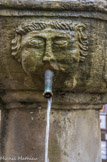 <center>Correns.</center> Fontaine de la place de l'église ... et de la mairie. Un des mascarons.